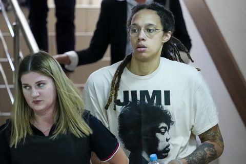 WNBA star and two-time Olympic gold medalist Brittney Griner, center, is escorted to a courtroom for a hearing, in Khimki just outside Moscow, Russia, Friday, July 1, 2022. Griner appeared in a Moscow-area court for trial Friday, about 4 1/2 months after she was arrested on cannabis possession charges at an airport while traveling to play for a Russian team. (AP Photo/Alexander Zemlianichenko)