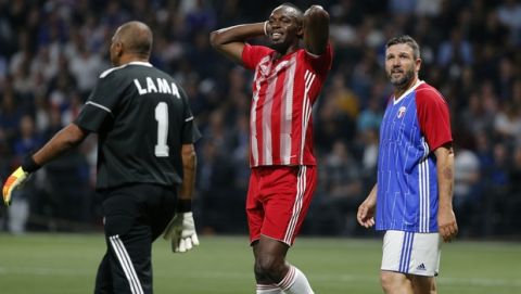 Former Olympic and Jamaican sprinter Usain Bolt, center, reacts during a charity soccer match between members of the 1998 World Cup winning French team and a team of international veteran players who were also involved in the same tournament, at the U Arena in Nanterre, north of Paris, France, Tuesday, June 12, 2018. (AP Photo/Thibault Camus)