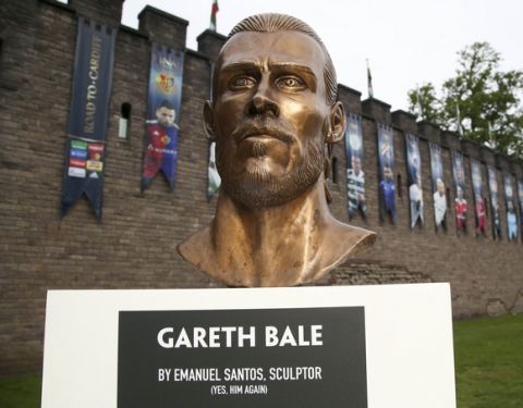 A bust of Real Madrid and Wales soccer player Gareth Bale, created by Emanuel Santos, the artist behind the recent Cristiano Ronaldo bust at Madeira airport, is placed on display after being unveiled in Cardiff, Wales Wednesday May 31, 2017, ahead of this weekend's Champions League final between Real Madrid and Juventus. (Geoff Caddick/PA via AP)