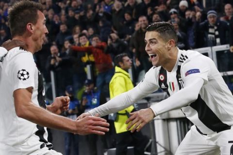 --ALTERNATIVE VERSION OF XLB133--Juventus forward Mario Mandzukic, left, celebrates with his teammate Cristiano Ronaldo after scoring during the Champions League group H soccer match between Juventus and Valencia at the Allianz stadium in Turin, Italy, Tuesday, Nov. 27, 2018. (AP Photo/Antonio Calanni)