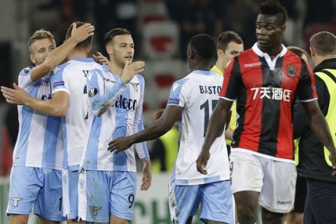Lazio players celebrates their 3-1 win over OGC Nice while Nice's Mario Balotelli, right, leaves the pitch, at the end of a Europa League group K soccer match between OGC Nice and Lazio at the Allianz Riviera stadium in Nice, French Riviera, Thursday, Oct. 19, 2017 (AP Photo/Claude Paris)