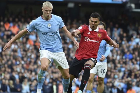 Manchester City's Erling Haaland, left, challenges for the ball with Manchester United's Casemiro during the English Premier League soccer match between Manchester City and Manchester United at Etihad stadium in Manchester, England, Sunday, Oct. 2, 2022. (AP Photo/Rui Vieira)