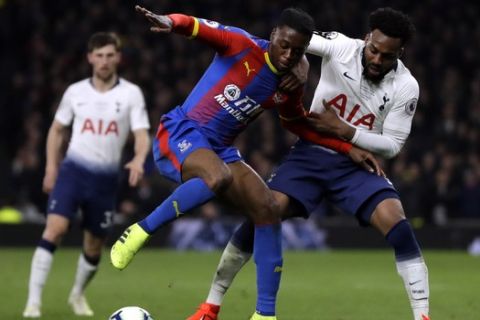 Tottenham's Danny Rose, right, fights for the ball with Crystal Palace's Aaron Wan-Bissaka during the English Premier League soccer match betweenTottenham Hotspur and Crystal Palace, the first Premiership match at the new Tottenham Hotspur stadium in London, Wednesday, April 3, 2019. (AP Photo/Kirsty Wigglesworth)
