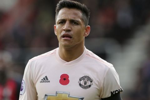 Manchester United's Alexis Sanchez wearing a black armband in memory of the victims of the Leicester helicopter crash, which included Leicester Chairman, Vichai Srivaddhanaprabha during the English Premier League soccer match between Bournemouth and Manchester United at The Vitality Stadium, Bournemouth, England.Saturday Nov. 3, 2018. (Mark Kerton/PA via AP)