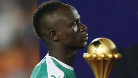 Senegal's Sadio Mane walks past the Cup after the African Cup of Nations final soccer match between Algeria and Senegal in Cairo International stadium in Cairo, Egypt, Friday, July 19, 2019. Algeria won 1-0. (AP Photo/Ariel Schalit)