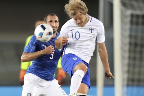 Italy's Giorgio Chiellini, left, challenges for the ball with Finland's Teemu Pukki during the international friendly soccer match between Italy and Finland, at the Bentegodi stadium in Verona, Italy, Monday, June 6, 2016. (AP Photo/Antonio Calanni)