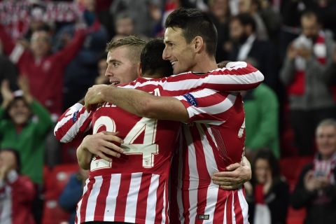 Athletic Bilbao's Aritz Aduriz, right, celebrates his goal with Mikel Balenziaga and Iker Muniain, left, during the Europa League Group F soccer match between Athletic Bilbao and Genk, at  the San Mames stadium, in Bilbao, northern Spain, Thursday, Nov. 3, 2016. (AP Photo/Alvaro Barrientos)