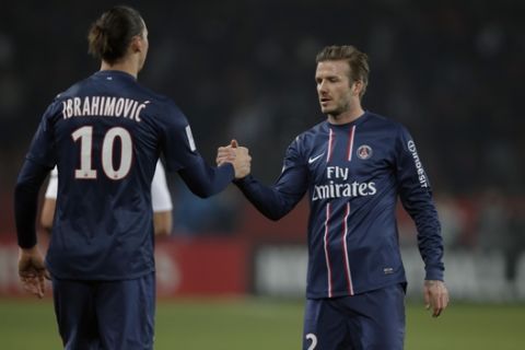Paris Saint Germain's Zlatan Ibrahimovic from Sweden shakes hands with David Beckham after their League One soccer match between PSG and Montpellier at Parc des Princes Stadium, in Paris, Friday March 29, 2013. (AP Photo/Francois Mori)