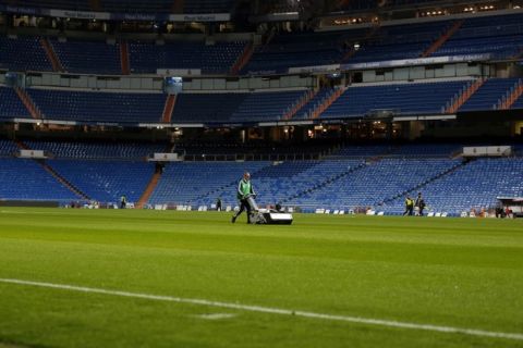 A groundsman mows the grass after Real Madrid's Copa del Rey soccer match against Melilla at the Santiago Bernabeu stadium in Madrid, Spain, Thursday, Dec. 6, 2018. The Copa Libertadores Final will be played on Dec. 9 in Spain at Real Madrid's stadium for security reasons after River Plate fans attacked the Boca Junior team bus heading into the Buenos Aires stadium for the meeting of Argentina's fiercest soccer rivals last Saturday. (AP Photo/Paul White)