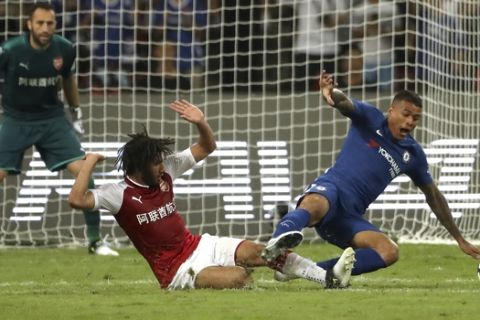 CAPTION CORRECTS THE NAME - Arsenal's Mohamed El Neny, left, tackles Chelsea's Kenedy during the second half of their friendly soccer match in Beijing, Saturday, July 22, 2017. Chelsea beat Arsenal 3-0. (AP Photo/Mark Schiefelbein)