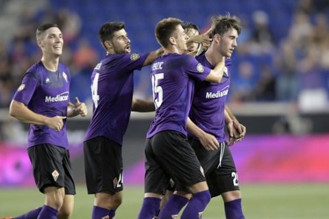 Benfica midfielder Pizzi, right, reacts as Fiorentina's Dusan Vlahovic (29) is congratulated by teammates after scoring a goal during the first half of an International Champions Cup soccer match Wednesday, July 24, 2019, in Harrison, N.J. (AP Photo/Bill Kostroun)