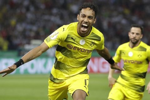 Dortmund's Pierre-Emerick Aubameyang, left, celebrates after scoring his side's 2nd goal during the German soccer cup final match between Borussia Dortmund and Eintracht Frankfurt in Berlin, Germany, Saturday, May 27, 2017. (AP Photo/Michael Sohn)