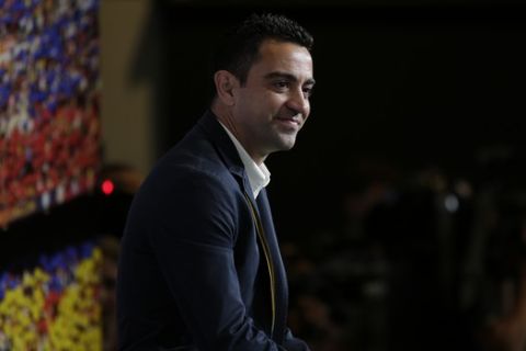 FC Barcelona Xavi Hernandez attends a conference for his farewell event at the Camp Nou stadium in Barcelona, Spain, Wednesday, June 3, 2015. FC Barcelona midfielder Xavi Hernandez says he will leave the Catalan club after 17 trophy-laden seasons in which he set club records for appearances and titles won. The 35-year-old Xavi says he will cut his contract short by one year and leave after this season to go play for Qatari club Al-Sadd on a two-year contract. (AP Photo/Manu Fernandez)