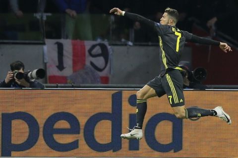 Juventus forward Cristiano Ronaldo celebrates after scoring his side's opening goal during the Champions League quarterfinal, first leg, soccer match between Ajax and Juventus at the Johan Cruyff ArenA in Amsterdam, Netherlands, Wednesday, April 10, 2019. (AP Photo/Peter Dejong)