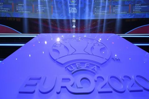 A scoreboard shows the final draw, except the play-off winners, for the UEFA Euro 2020 soccer tournament finals in Bucharest, Romania, Saturday, Nov. 30, 2019. (AP Photo/Andreea Alexandru)