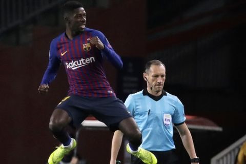 Barcelona forward Ousmane Dembele celebrates after scoring the opening goal during the Champions League group B soccer match between FC Barcelona and Tottenham Hotspur at the Camp Nou stadium in Barcelona, Spain, Tuesday, Dec. 11, 2018. (AP Photo/Emilio Morenatti)