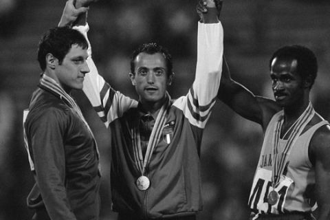 Pietro Mennea, center, gold medal winner of the mens 200-meter Olympic race, holds up hands of silver medalist Allan Wells of Britain, left, and bronze medalist Don Quarrie of Jamaica, right, during awards ceremony in Moscow on July 29, 1980. All three runners finished within tenths of seconds of each other. (AP Photo)