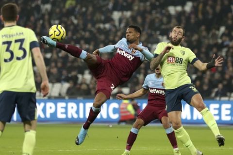 West Ham United's Sebastien Haller, centre left, reaches out to score his side's second goal of the game against Bournemouth, during their English Premier League soccer match at the London Stadium, in London, Wednesday Jan. 1, 2020. (Bradley Collyer/PA via AP)