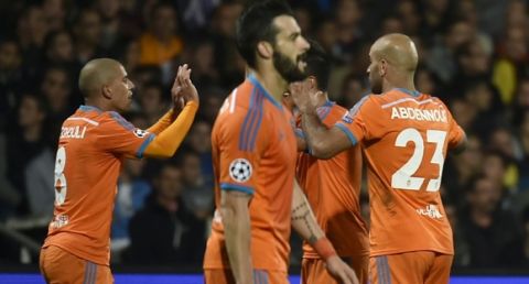 Valencia's Algerian midfielder Sofiane Feghouli (L) celebrates with teammates after scoring a goal during the Champions League group H football match between Lyon and Valencia on September 29, 2015 at the Gerland stadium in Lyon, central-eastern France.   AFP PHOTO / JEFF PACHOUD        (Photo credit should read JEFF PACHOUD/AFP/Getty Images)
