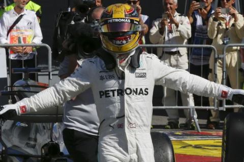 Mercedes driver Lewis Hamilton of Britain celebrates after winning the Italian Formula One Grand Prix, at the Monza racetrack, Italy, Sunday, Sept. 3, 2017. (AP Photo/Luca Bruno)