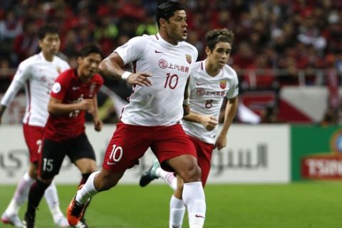 In this Oct. 18, 2017 photo, Shanghai SIPG's Hulk, center, controls the ball, with Oscar, right, both of Brazil in the second leg of their Asian Champions League soccer semifinal against Urawa Reds in Saitama. The spending may have slowed but world-famous coaches such as Fabio Capello and Manuel Pellegrini and players like Hulk and Javier Mascherano still have the same objective in the 2018 Chinese Super League that kicks off on Friday: to stop Guangzhou Evergande from winning an eighth consecutive title.(AP Photo/Shuji Kajiyama)