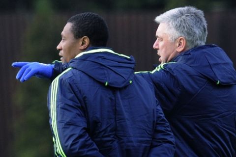 Chelsea manager Carlo Ancelotti, right, talks to his new assistant  Michael Emenalo at the Cobham training ground, Cobham, England, Monday, Nov. 22, 2010. Chelsea will face MSK Zilila in a Champions League group F soccer match at the Stamford Bridge stadium, London, Tuesday. (AP Photo/Tom Hevezi)