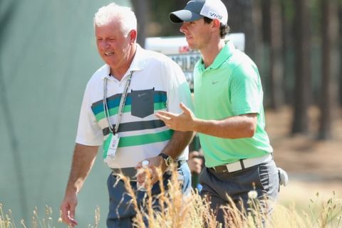 PINEHURST, NC - JUNE 10:  Rory McIlroy (R) of Northern Ireland talks with his dad Gerry McIlroy (L) during a practice round prior to the start of the 114th U.S. Open at Pinehurst Resort & Country Club, Course No. 2 on June 10, 2014 in Pinehurst, North Carolina.  (Photo by Andrew Redington/Getty Images) ORG XMIT: 461911043 ORIG FILE ID: 450396846