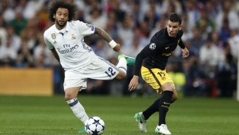 Real Madrid's Marcelo fights for the ball against Atletico's Lucas Hernandez during the Champions League semifinal first leg soccer match between Real Madrid and Atletico Madrid at the Santiago Bernabeu stadium in Madrid, Spain, Tuesday, May 2, 2017. (AP Photo/Francisco Seco)