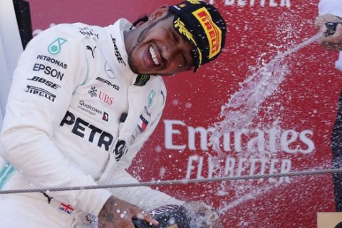 Mercedes driver Lewis Hamilton of Britain sprays champagne on the podium after winning the Spanish Formula One race at the Barcelona Catalunya racetrack in Montmelo, just outside Barcelona, Spain, Sunday, May 12, 2019. (AP Photo/Manu Fernandez)