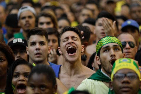 Brazil soccer fans watch a live broadcast of the Russia World Cup quarterfinal match between Brazil and Belgium, in Rio de Janeiro, Brazil, Friday, July 6, 2018. (AP Photo/Leo Correa)