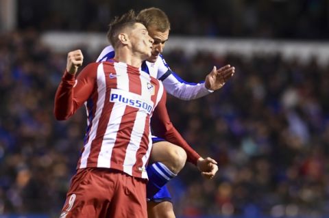 In this photo taken Thursday March 2, 2017, Atletico Madrid's Fernando Torres, left and Deportivo La Coruna's Alex Bergantinos clash with their heads while jumping for the ball during a La Liga soccer match at the Riazor stadium in La Coruna, Spain. Atletico Madrid says Torres has been released from the hospital Friday following the clash of heads after a CAT scan did not reveal any damage to his head or neck. (AP Photo/Carlos Pardellas)