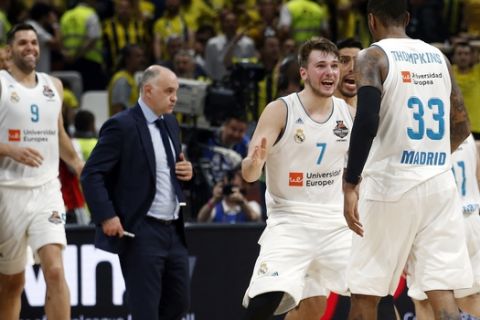 Real Madrid's Luka Doncic reacts with Real Madrid's Trey Thompkins after winning their Final Four Euroleague final basketball match against Fenerbahce in Belgrade, Serbia, Sunday, May 20, 2018. (AP Photo/Darko Vojinovic)