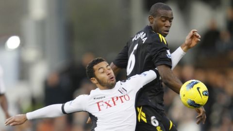 Fulham's Mousa Dembele, left, challenges for the ball with Bolton Wanderers' Fabrice Muamba during their English Premier League soccer match at Fulham's Craven Cottage stadium in London, Saturday, Dec.  17, 2011. (AP Photo/Alastair Grant)