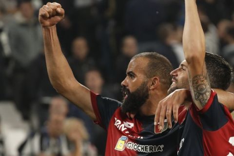 Genoa's Daniel Bessa, right, who scored the equalizer, and Genoa's Sandro celebrate at the end of an Italian Serie A soccer match between Juventus and Genoa, at the Alliance stadium in Turin, Italy, Saturday, Oct. 20, 2018. The match ended in a 1 - 1 tie. (AP Photo/Antonio Calanni)