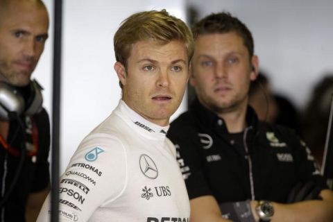 Mercedes driver Nico Rosberg of Germany looks out from the team box during the first free practice at the Yas Marina racetrack in Abu Dhabi, United Arab Emirates, Friday, Nov. 25, 2016. The Emirates Formula One Grand Prix will take place on Sunday. (AP Photo/Luca Bruno)