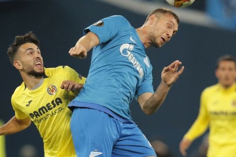 Villarreal's Manu Morlanes, left, and Zenit's Artem Dzyuba challenge the ball during the Europa League round of 16, 1st leg soccer match between Zenit St.Petersburg and Villarreal at the Saint Petersburg stadium, in St.Petersburg, Russia, Thursday, March 7, 2019. (AP Photo/Dmitri Lovetsky)