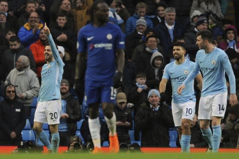 Manchester City's Bernardo Silva, left, celebrates after scoring his side's opening goal during the English Premier League soccer match between Manchester City and Chelsea at the Etihad Stadium in Manchester, England, Sunday, March 4, 2018. (AP Photo/Rui Vieira)