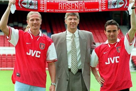 Library file picture dated 17/06/97 of Arsenal manager Arsene Wenger (centre) flanked by the club's two new signings Emmanuel Petit (left) and Marc Overmars. Arsenal have agreed to sell Dutch winger Marc Overmars and the French World Cup-winning midfielder Emmanuel Petit to Barcelona for a combined fee believed to be more than £30million. See PA story SOCCER Arsenal. PA Photo : Michael Stephens