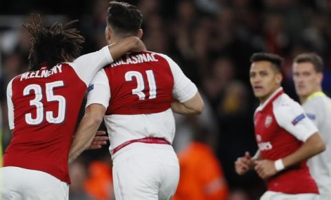 Arsenal's Sead Kolasinac, second from left, celebrates with teammates after scoring during the Europa League group H soccer match between Arsenal and FC Cologne at the Emirates stadium in London, England, Thursday, Sept. 14, 2017 . (AP Photo/Kirsty Wigglesworth)