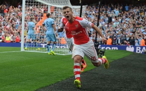 LONDON, ENGLAND - SEPTEMBER 13:  Jack Wilshere celebrates scoring for Arsenal during the Barclays Premier League match between Arsenal and Manchester City at Emirates Stadium on September 13, 2014 in London, England.  (Photo by Stuart MacFarlane/Arsenal FC via Getty Images)