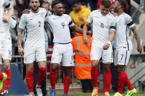 England's scorer Jermain Defoe, 3rd right, and his teammates celebrate the opening goal during the World Cup Group F qualifying soccer match between England and Lithuania at the Wembley Stadium in London, Great Britain, Sunday, March 26, 2017. (AP Photo/Kirsty Wigglesworth)
