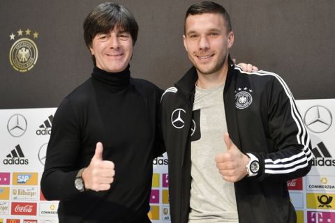Germany's forward Lukas Podolski, right, and national head coach Joachim Loew show thumbs up at a press conference prior the friendly soccer match between Germany and England in Dortmund, Germany, Tuesday, March 21, 2017. Podolski will play his last match for the national team against England on Wednesday. (AP Photo/Martin Meissner)