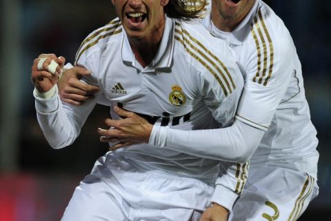 Real Madrid's defender Sergio Ramos (L) and Real Madrid's Portuguese defender Pepe (R) celebrate after scoring their first goal during their Spanish league football match Getafe against Real Madrid at Alfonso Perez stadium on February 4, 2011 in Getafe, near Madrid.  AFP PHOTO/ JAVIER SORIANO (Photo credit should read JAVIER SORIANO/AFP/Getty Images)