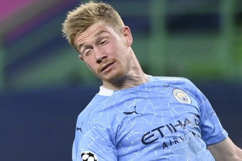Lyon's Houssem Aouar, left, and Manchester City's Kevin De Bruyne battle for the ball during the Champions League quarterfinal match between Manchester City and Lyon at the Jose Alvalade stadium in Lisbon, Portugal, Saturday, Aug. 15, 2020. (Franck Fife/Pool Photo via AP)