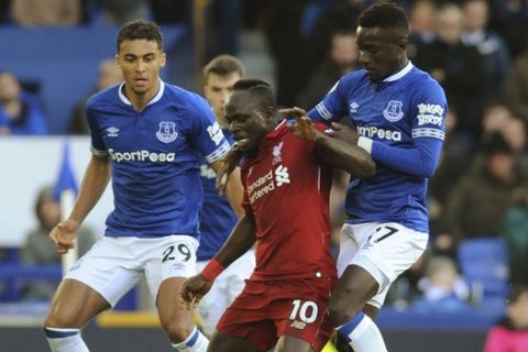 Liverpool's Sadio Mane, left, challenges for the ball with Everton's Idrissa Gueye during the English Premier League soccer match between Everton and Liverpool at Goodison Park in Liverpool, England, Sunday, March 3, 2019. (AP Photo/Rui Vieira)