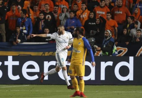 Real Madrid's Karim Benzema, left, celebrates after scoring the fourth goal of his team during the Champions League Group H soccer match between APOEL Nicosia and Real Madrid at GSP stadium, in Nicosia, on Tuesday, Nov. 21, 2017. (AP Photo/Petros Karadjias)