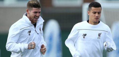 LIVERPOOL, ENGLAND - SEPTEMBER 30:  Philippe Coutinho and Alberto Moreno shares a joke during a Liverpool FC training session at Melwood Training Ground on September 30, 2015 in Liverpool, England.  (Photo by Jan Kruger/Getty Images)