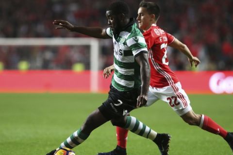 Sporting's Joel Campbell, left, drives the ball away from Benfica's Franco Cervi during a Portuguese league soccer match between Benfica and Sporting at the Luz stadium in Lisbon, Sunday, Dec. 11, 2016. (AP Photo/Armando Franca)