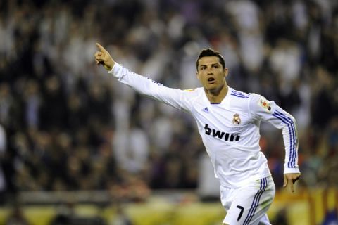 Real Madrid's Portuguese forward Cristiano Ronaldo celebrates after scoring during the Spanish Cup final match Real Madrid against Barcelona at the Mestalla stadium in Valencia on April 20, 2011.   AFP PHOTO / PIERRE-PHILIPPE MARCOU (Photo credit should read PIERRE-PHILIPPE MARCOU/AFP/Getty Images)