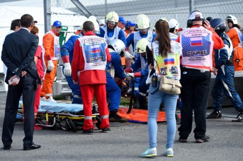 SOCHI, RUSSIA - OCTOBER 10:  Doctors assist Carlos Sainz of Spain and Scuderia Toro Rosso after he crashed during final practice for the Formula One Grand Prix of Russia at Sochi Autodrom on October 10, 2015 in Sochi, Russia.  (Photo by Lars Baron/Getty Images)